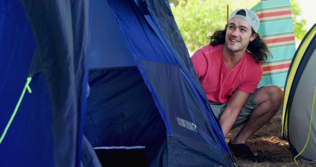 Young Man Setting Up Tent at Campsite on Sunny Day - Download Free Stock Images Pikwizard.com