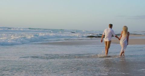 Romantic Couple Walking on Beach During Sunset - Download Free Stock Images Pikwizard.com