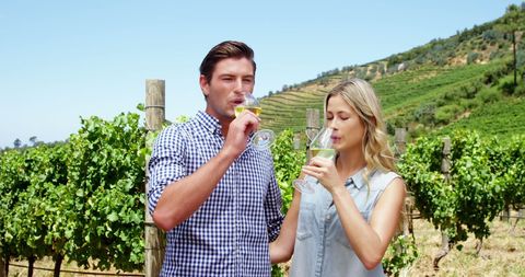 Couple Savoring Wine in Picturesque Vineyard - Download Free Stock Images Pikwizard.com