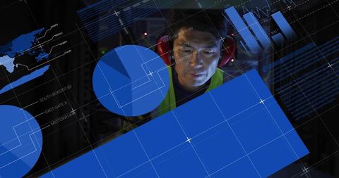 Korean technician monitoring industrial data dashboards with blue analytics overlays
