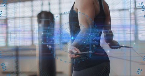 Female athlete holding jump rope in gym with futuristic hud fitness overlay