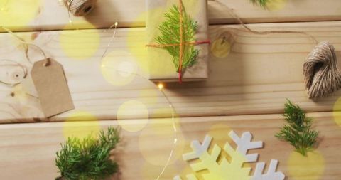Rustic Holiday Gift Flatlay Featuring Kraft-Wrapped Present, Twine, Tags and Evergreen