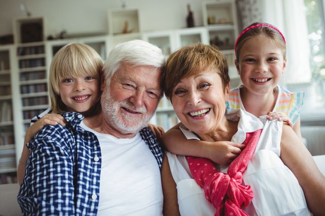 Portrait of grandparents smiling with their grandchildren at home