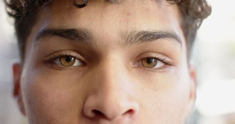 Close-Up Portrait of Young Man with Amber Eyes