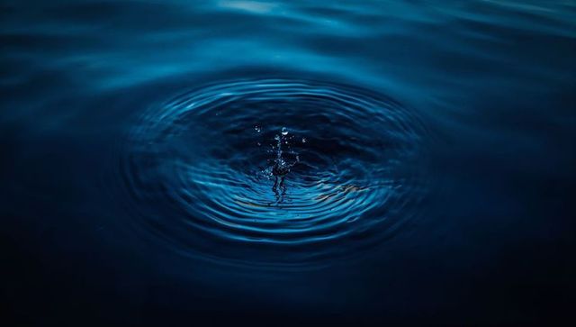 Minimalistic Rippling Water with Droplet Splash in Low Light