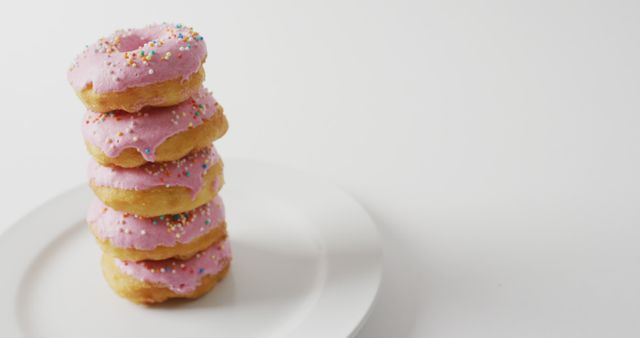 Stack of Pink Frosted Donuts with Sprinkles on White Plate - Download Free Stock Images Pikwizard.com