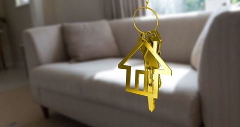 Golden house keyring with keys in luxurious minimalist living room