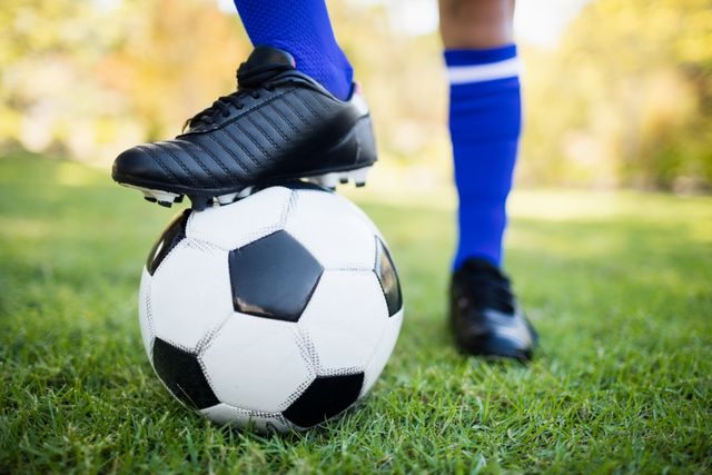 Perfect for illustrating sports activities, youth soccer, outdoor recreation, and athletic footwear. Ideal for use in sports magazines, promotional materials for soccer events, and fitness blogs.