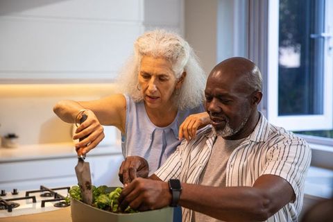 Senior couple enjoying home cooking experience together in kitchen