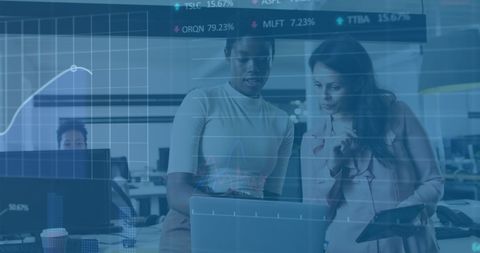 Business professionals analyzing stock data in modern office