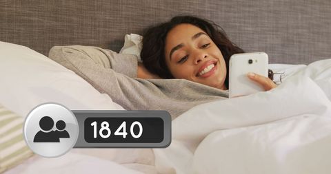 Woman Relaxing in Bed Receiving Friend Requests on Smartphone