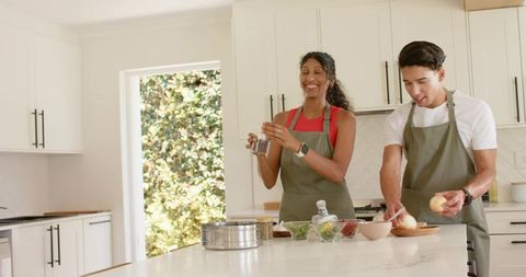 African American Couple Cooking Together in Bright Modern Kitchen Preparing Healthy Meal