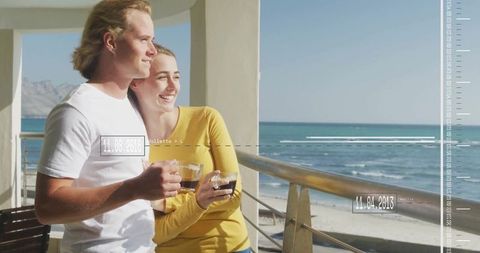 Couple Enjoying Coffee on Coastal Balcony with Sea View