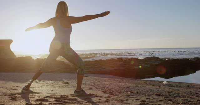 Woman with Prosthetic Leg Practicing Yoga on Beach at Sunset - Download Free Stock Images Pikwizard.com