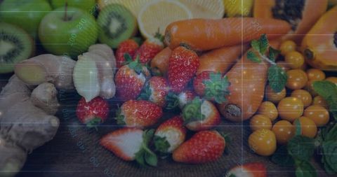 Ripe strawberries nesting among carrots and golden tomatoes with digital grid overlay