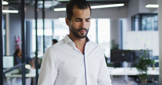 Confident Businessman in Modern Office Wearing White Collar Shirt - Download Free Stock Images Pikwizard.com