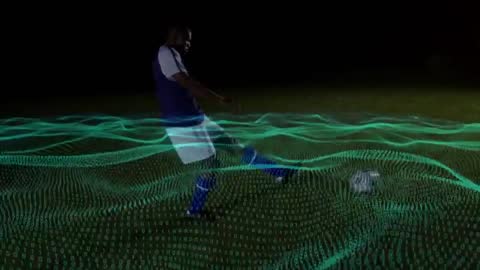 Soccer player approaching and kicking through futuristic teal data mesh on night field