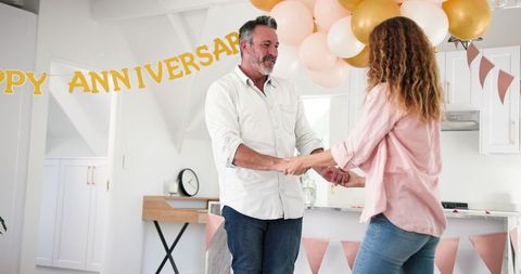 Couple celebrating anniversary with dance at home