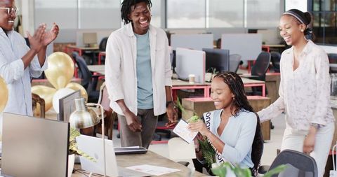 African American Colleagues Celebrating Success in Modern Office
