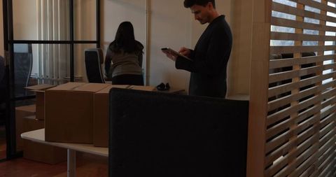 Businessman using tablet during office relocation