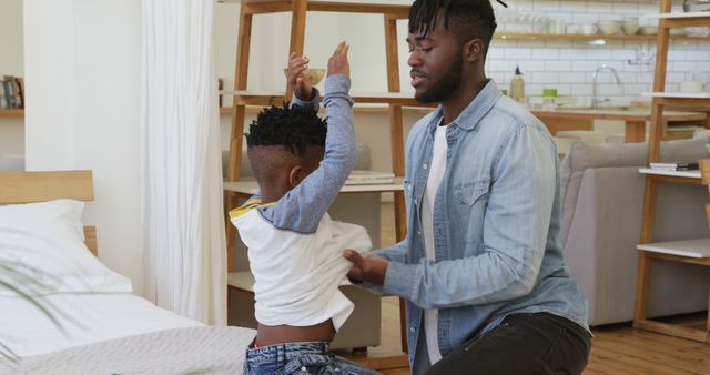 Father Helping Son Get Dressed in Modern Home Interior - Download Free Stock Images Pikwizard.com