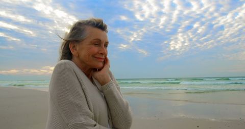 Joyful Senior Woman Embracing Serene Beach Sunset - Download Free Stock Images Pikwizard.com