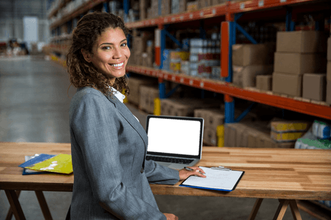 Transparent Clipboard Posing Businesswoman in Warehouse
