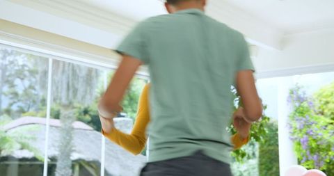 Young couple dancing joyfully in living room decor