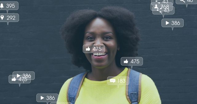 Afro-haired woman smiling while engaging on social media with various like and comment counters. Ideal for illustrating concepts of social media influence, digital communication, user engagement, online networking, and internet culture. Useful for articles on social media trends, marketing strategies, and the impact of digital presence.