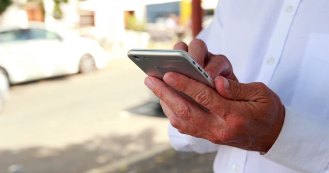 Close-Up of Hands Using Smartphone Outdoors in Urban Environment - Download Free Stock Images Pikwizard.com