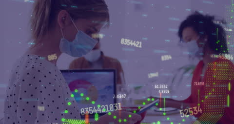 Business Professionals Analyzing Financial Data with COVID-19 Precautions