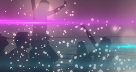 Silhouetted Friends Celebrating by Beach with Bokeh effects