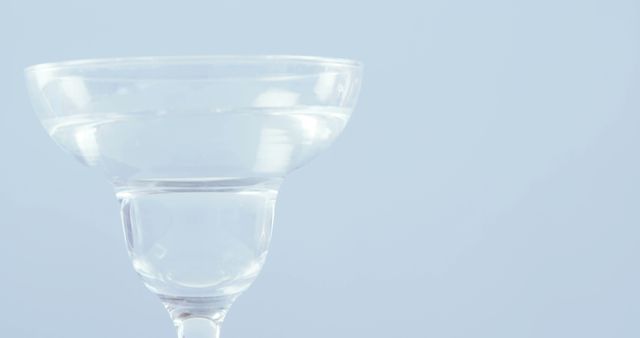 A clear glass with a transparent liquid is set against a light blue background, with copy space - Download Free Stock Photos Pikwizard.com