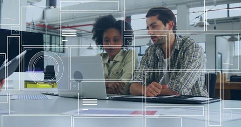 Coworkers Collaborating on Project with Laptop in Modern Office