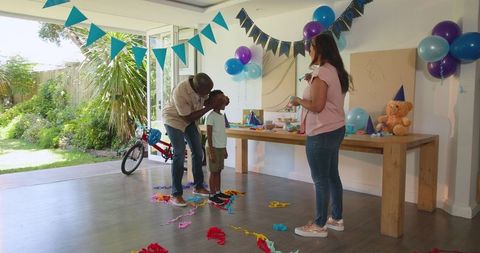 Diverse Family Celebrating Birthday with Decorations at Home