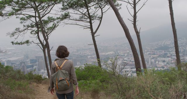 Woman Hiking in Nature Overlooking Cityscape on Cloudy Day - Download Free Stock Images Pikwizard.com