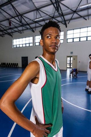 Confident Young Athlete Preparing for Basketball Game Indoors