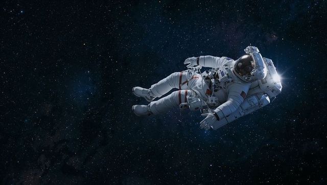 Floating Astronaut Drifting through Deep Space with SAFER Backpack and Reflective Visor