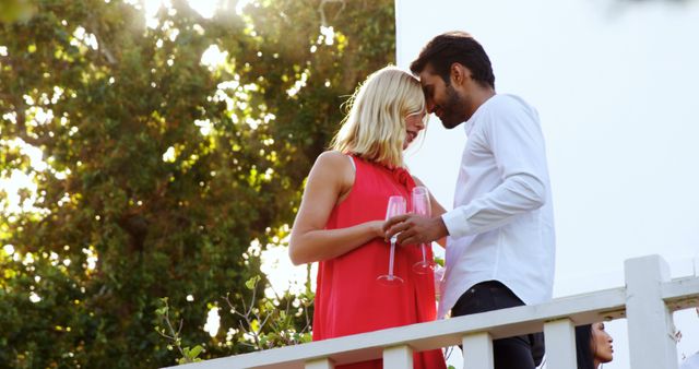 Romantic Couple Embracing on Outdoor Balcony with Champagne Glasses - Download Free Stock Images Pikwizard.com