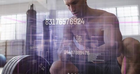 Athlete analyzing biometrics during workout in modern gym