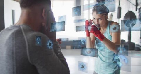 Female boxer training with coach using augmented reality hud for boxing sparring drills