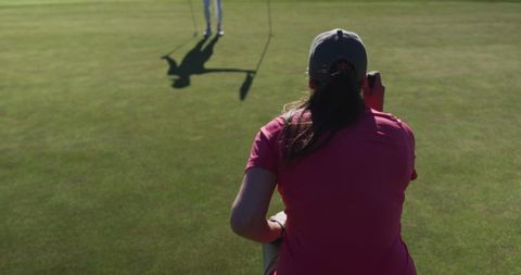 Female Golfers Sharing Encouraging Moment on Green