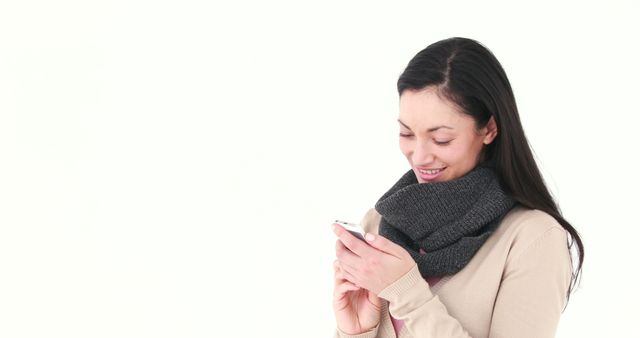 Woman Smiling While Texting on Smartphone, White Background - Download Free Stock Images Pikwizard.com