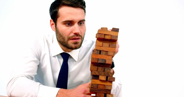 Focused Young Man Playing Jenga Indoor Activity - Download Free Stock Images Pikwizard.com