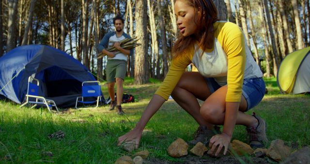 Couple Setting Up Camp in Forest with Tents and Firewood - Download Free Stock Images Pikwizard.com