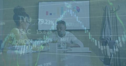 Young Professionals Discussing Financial Reports with Stock Market Overlay