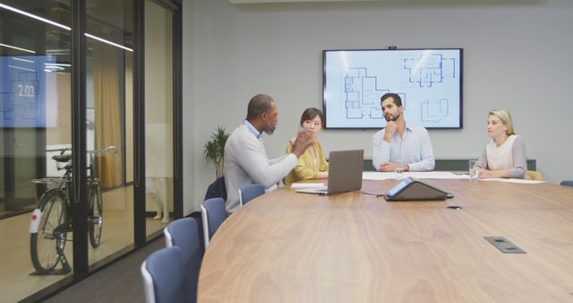 Diverse team working on project in modern conference room - Download Free Stock Images Pikwizard.com