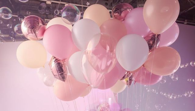 Floating pastel rosegold balloon cluster with soap bubbles for party decor