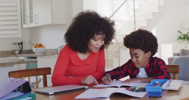 Mother Helping Son with Homework at Kitchen Table - Download Free Stock Images Pikwizard.com