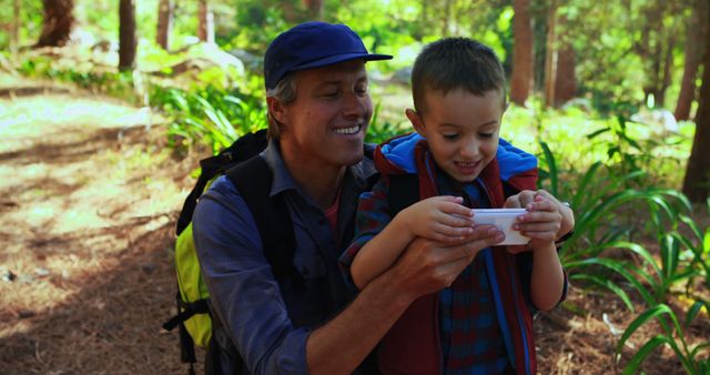 Father and Son Exploring Nature Together with Mobile Device - Download Free Stock Images Pikwizard.com